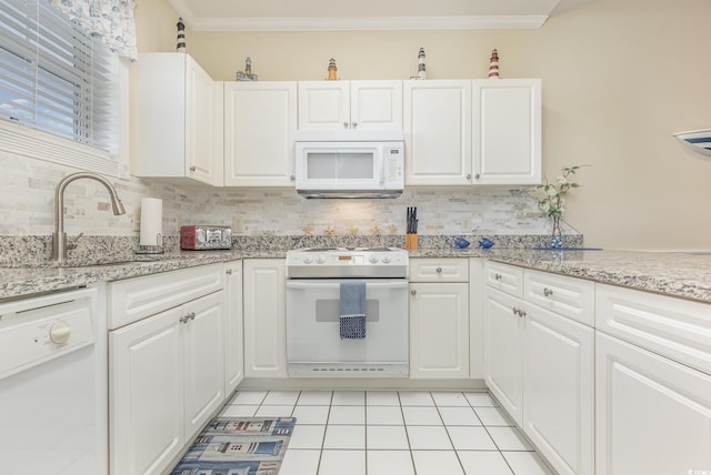 kitchen with white appliances and white cabinetry