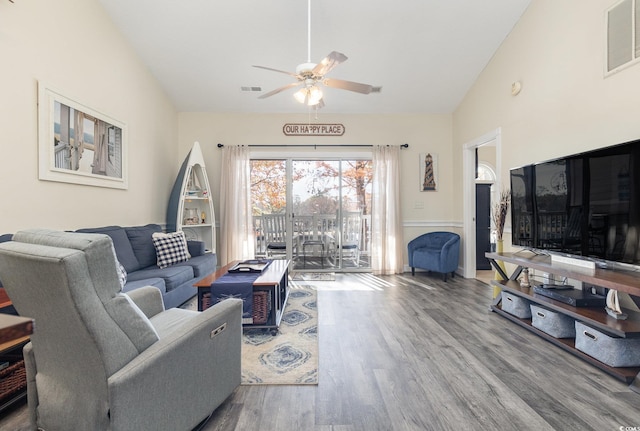 living room featuring hardwood / wood-style floors, ceiling fan, and lofted ceiling