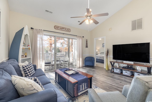 living room with ceiling fan, vaulted ceiling, and light hardwood / wood-style flooring