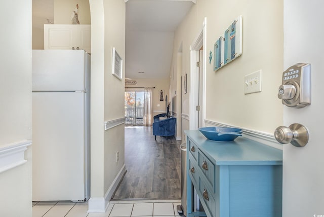 hall featuring light tile patterned floors