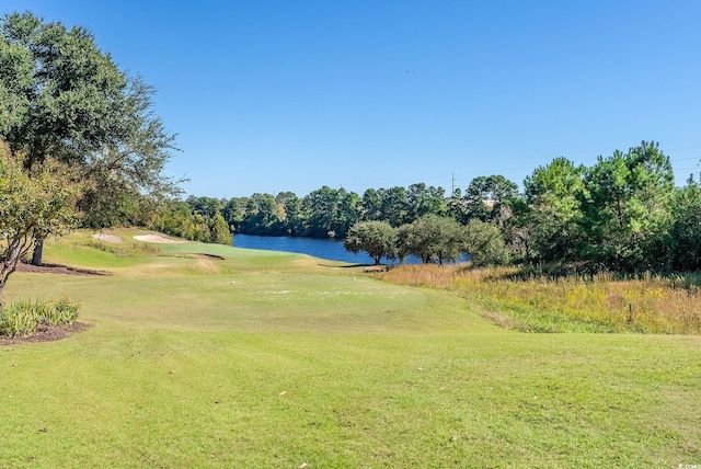 view of property's community featuring a yard and a water view