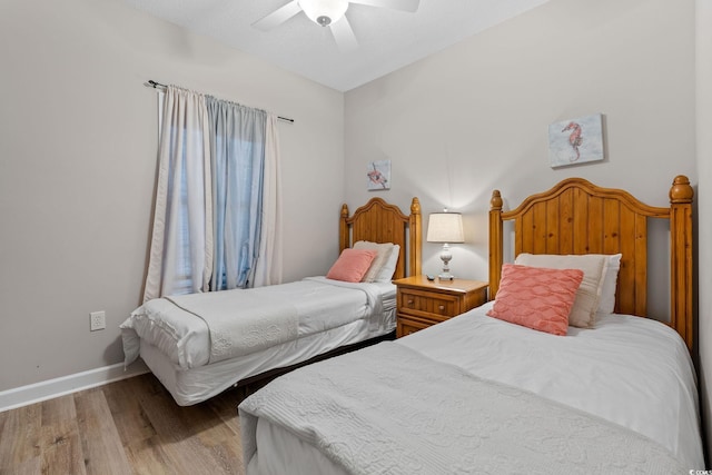 bedroom with ceiling fan and light hardwood / wood-style flooring