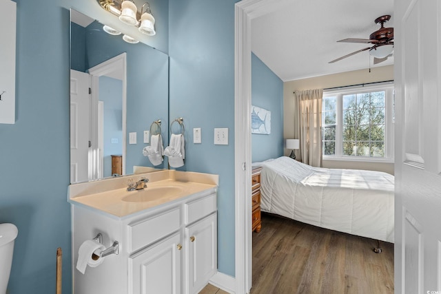 bathroom featuring ceiling fan, toilet, wood-type flooring, and vanity