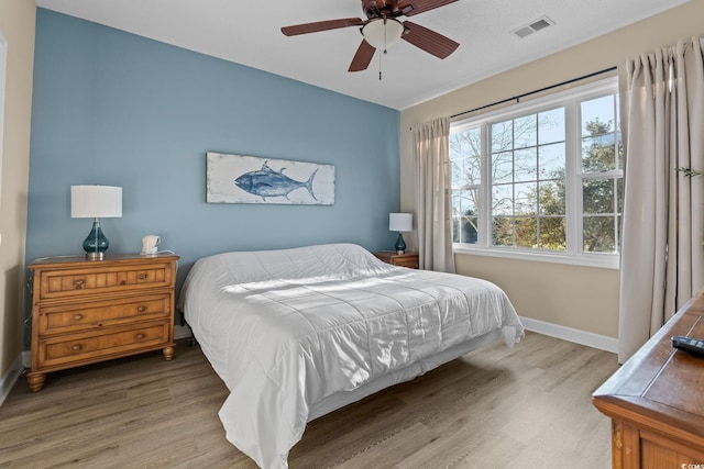 bedroom with hardwood / wood-style floors and ceiling fan