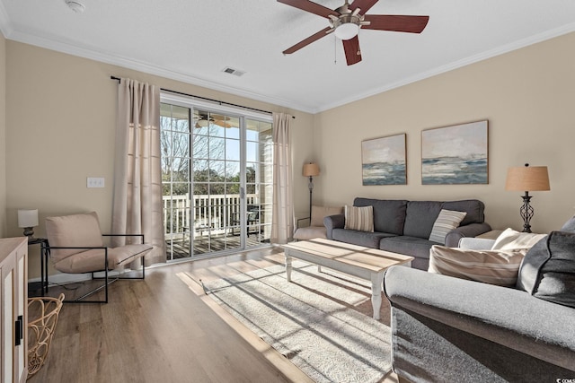 living room featuring hardwood / wood-style flooring and crown molding