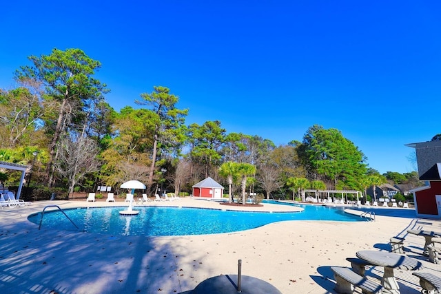 view of pool featuring pool water feature and a patio area