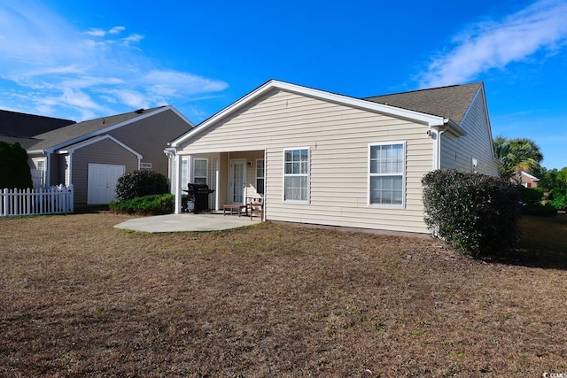 rear view of property with a yard