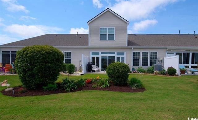 back of house featuring a yard