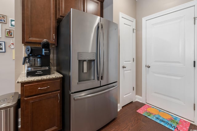 135 Parmelee Dr Unit D, Murrells Inlet, SC 29576 - kitchen with stainless steel fridge with ice dispenser, dark wood-style flooring, baseboards, dark brown cabinetry, and light stone counters