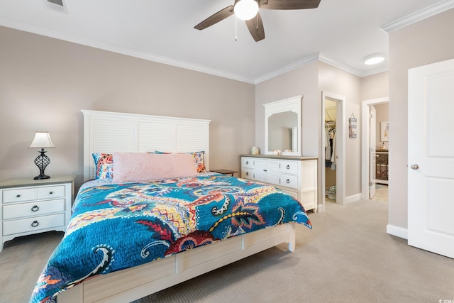 carpeted bedroom featuring a walk in closet, a closet, ceiling fan, and ornamental molding