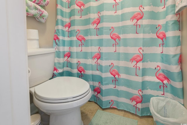 bathroom featuring curtained shower and toilet