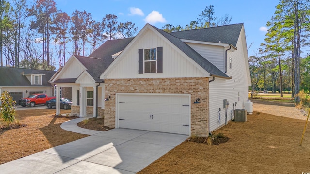 view of front of property featuring central AC unit and a garage