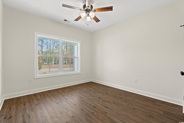 unfurnished room with ceiling fan and dark wood-type flooring