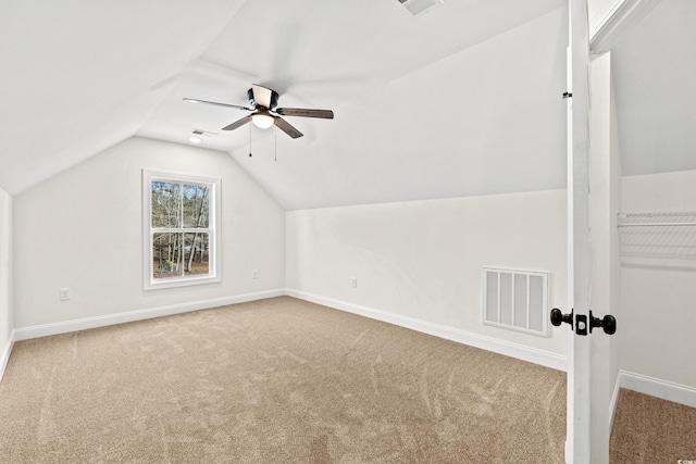 additional living space featuring carpet, vaulted ceiling, and ceiling fan