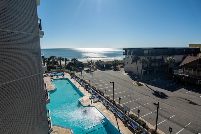 view of swimming pool featuring a water view