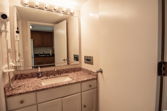 bathroom featuring vanity and a textured ceiling