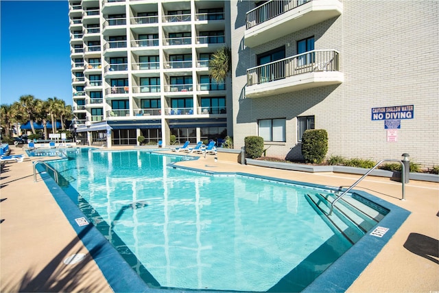 view of swimming pool featuring a patio area