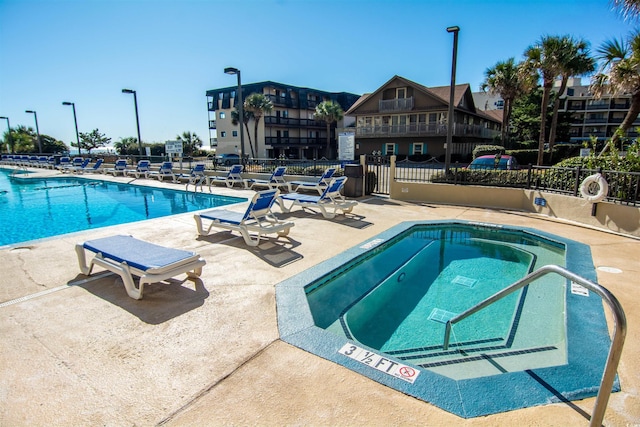 view of pool featuring a patio area and a community hot tub