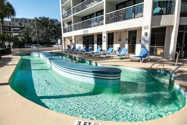 view of swimming pool featuring a patio area