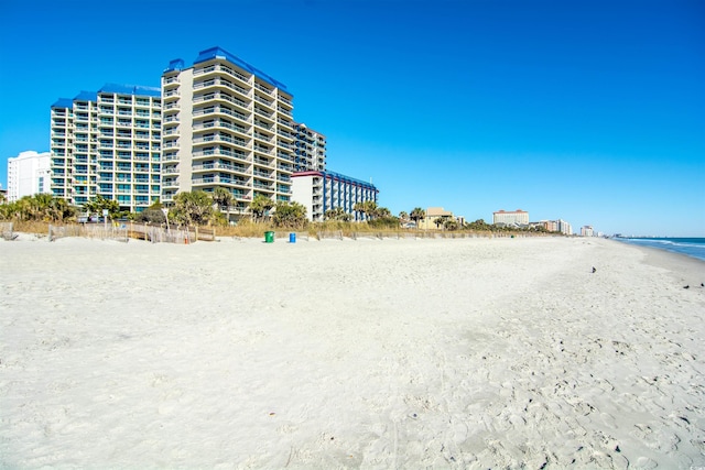 view of building exterior featuring a view of the beach and a water view