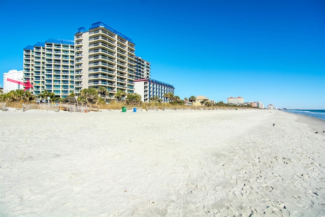 view of building exterior with a view of the beach and a water view