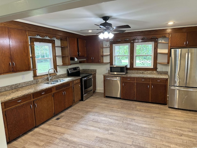 kitchen with ceiling fan, sink, a healthy amount of sunlight, light hardwood / wood-style floors, and appliances with stainless steel finishes