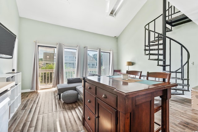 interior space featuring light hardwood / wood-style flooring and vaulted ceiling