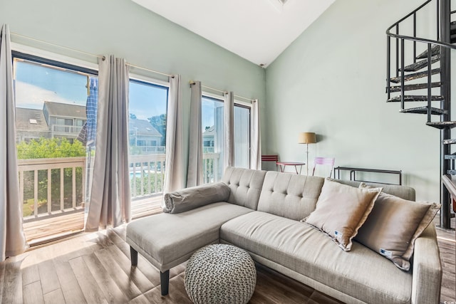 living room with light hardwood / wood-style flooring and vaulted ceiling