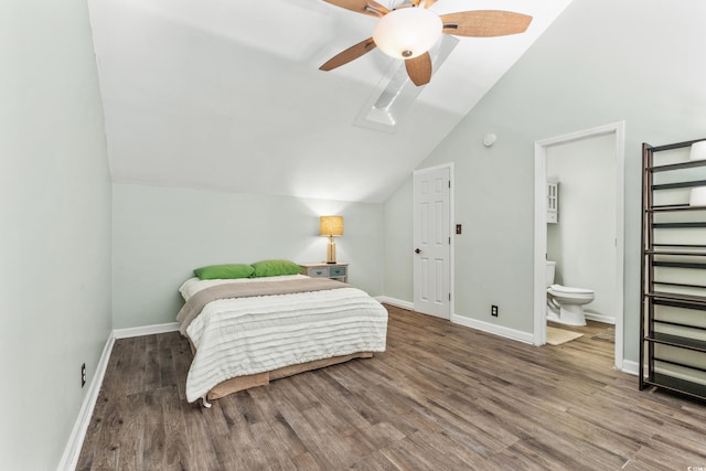 bedroom featuring ceiling fan, ensuite bathroom, vaulted ceiling, and hardwood / wood-style flooring