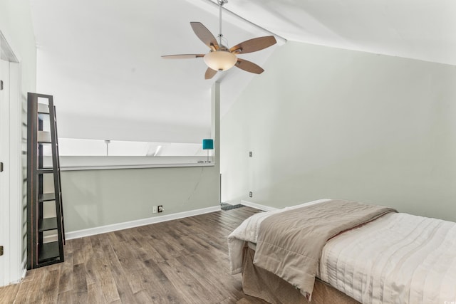 bedroom with hardwood / wood-style floors, vaulted ceiling with beams, and ceiling fan