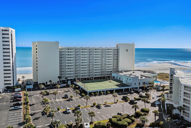 drone / aerial view featuring a water view and a beach view