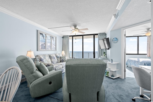 carpeted living room featuring a textured ceiling, floor to ceiling windows, crown molding, and ceiling fan