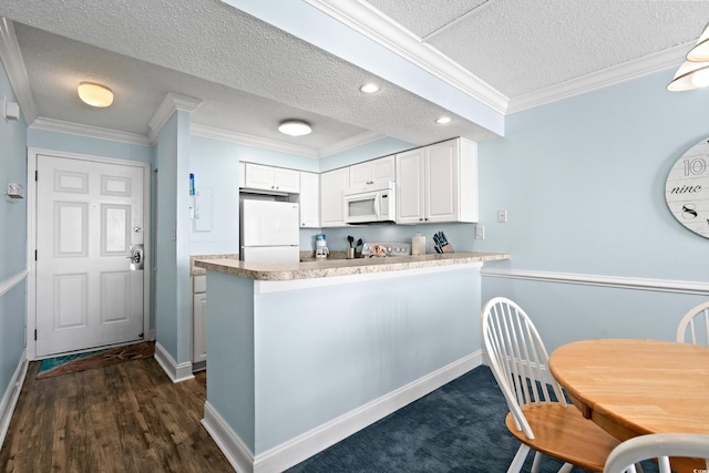 kitchen with white cabinets, white appliances, kitchen peninsula, and a textured ceiling