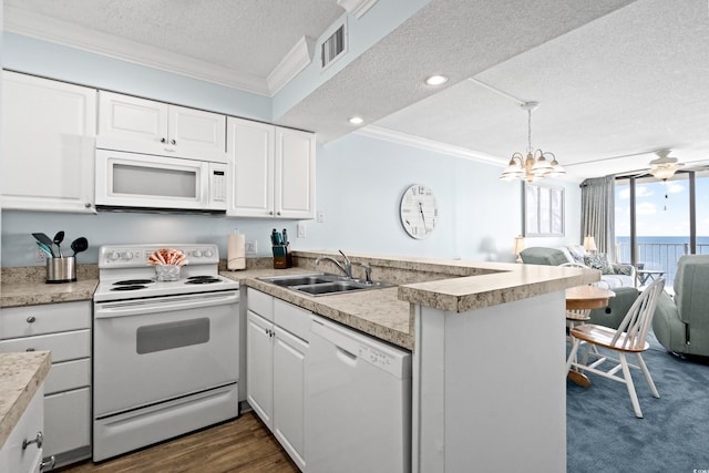 kitchen with a textured ceiling, kitchen peninsula, white cabinetry, and white appliances