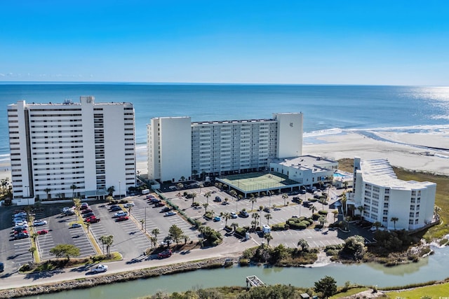 drone / aerial view featuring a water view and a view of the beach