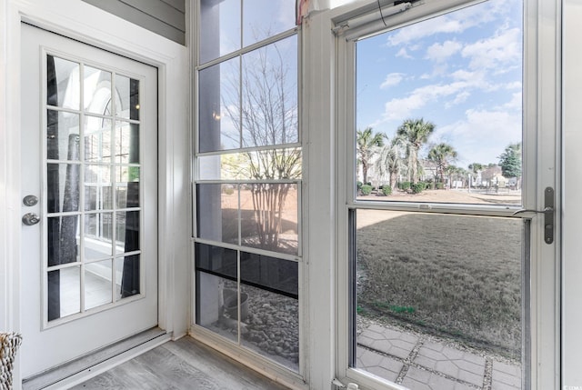 doorway to outside with wood-type flooring