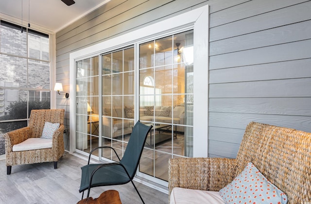 interior space with wood walls, hardwood / wood-style floors, and ceiling fan