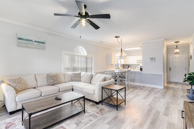 living room featuring ceiling fan with notable chandelier, light hardwood / wood-style flooring, and ornamental molding