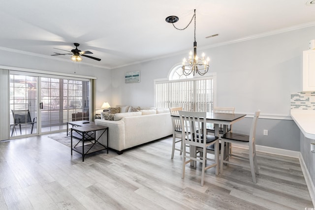 living room featuring ceiling fan with notable chandelier, ornamental molding, and light hardwood / wood-style flooring