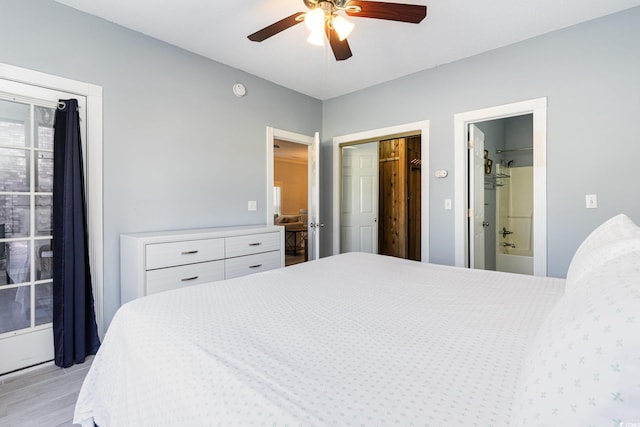 bedroom featuring ensuite bath, ceiling fan, and light wood-type flooring