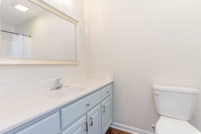 bathroom featuring vanity, toilet, and a shower with shower curtain