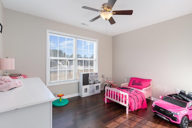 bedroom with dark hardwood / wood-style floors and ceiling fan