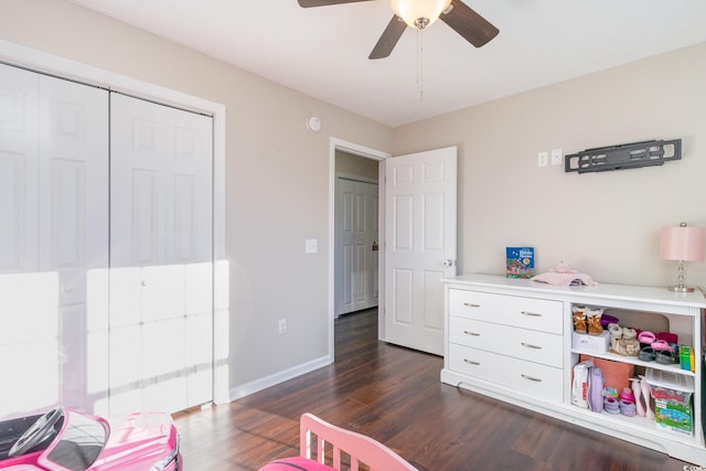 bedroom featuring ceiling fan, dark hardwood / wood-style flooring, and a closet