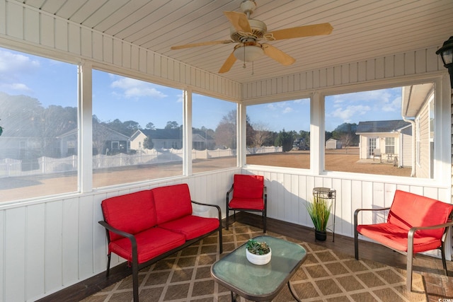 sunroom featuring ceiling fan