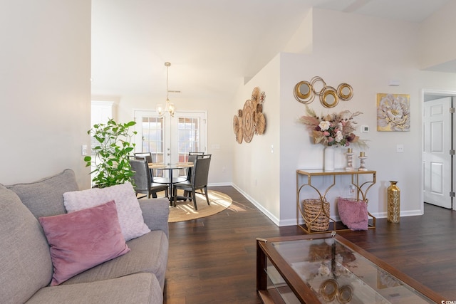 living room with lofted ceiling, a notable chandelier, and dark hardwood / wood-style floors