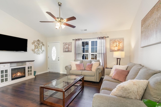 living room featuring vaulted ceiling, dark hardwood / wood-style floors, and ceiling fan