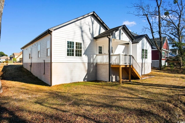 back of property featuring a lawn