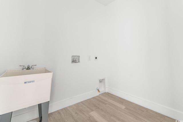 laundry room with hookup for a gas dryer, sink, hookup for a washing machine, light wood-type flooring, and hookup for an electric dryer