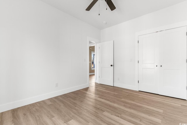 unfurnished bedroom with ceiling fan, a closet, and light hardwood / wood-style flooring