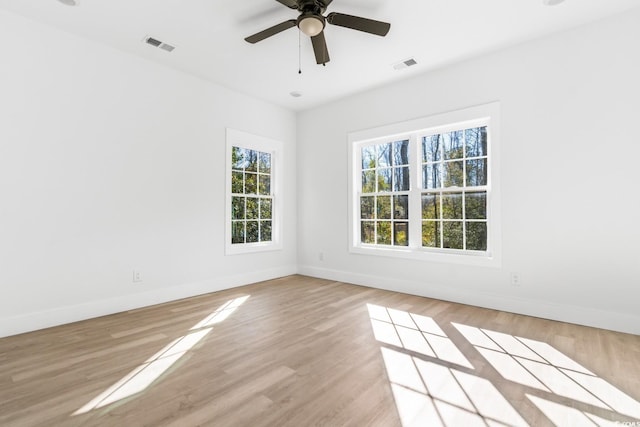 spare room with ceiling fan and light wood-type flooring